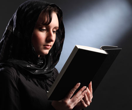 veiled woman reading